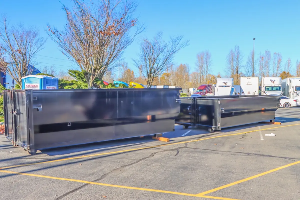 Professional dumpster rental service with roll-off container on residential driveway in Fort Wayne